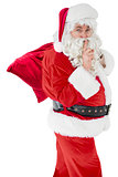 Santa keeping a secret and holding his sack