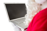 Father christmas using his laptop