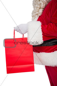 Father santa holding a shopping bag