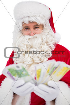Happy santa claus showing his cash
