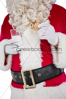 Santa holding glass of milk and cookie