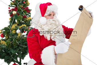 Santa with glasses reading a parchment