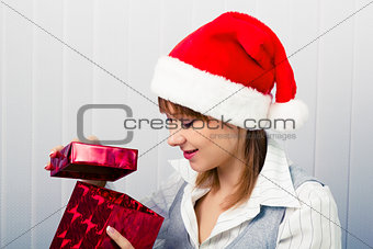 girl in the office in Santa hats with a gift