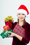 happy girl in santa hat with gift boxes