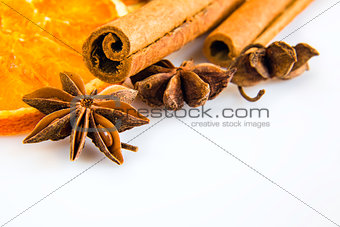 some anise stars and cassia cinnamon with dried orange rings