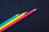 Different color pencils sharpened on dark background