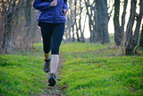 Young Sports Woman Running on the Forest Trail in the Morning