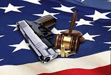Hand Gun with Gavel and Bullets on American Flag