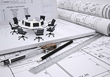 Round table, compasses, scrolls, architectural drawing and laptop