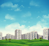High-rise buildings over green hills