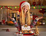 Portrait of happy teenager girl in santa hat with christmas cook