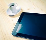 cup of coffee near a tablet, concept of new technology