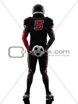 american football player holding soccer ball  silhouette