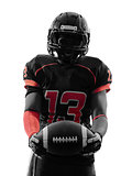 american football player standing holding ball silhouette