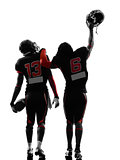 two american football players walking rear view silhouette