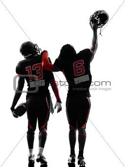 two american football players walking rear view silhouette