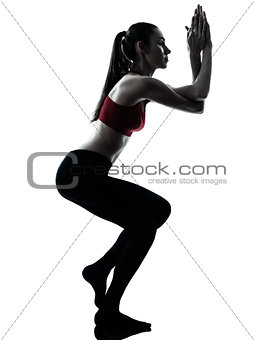 woman exercising yoga eagle pose silhouette