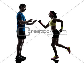 woman exercising jogging man coach using digital tablet  silhoue