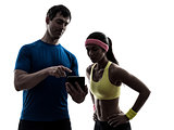 woman exercising fitness  man coach using digital tablet  silhou