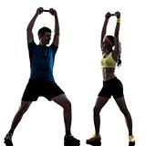 woman exercising fitness weight training with man coach silhouet