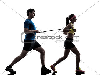 woman exercising fitness resistance  rubber band with man coach 