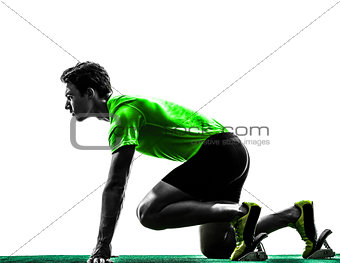young man sprinter runner in starting blocks silhouette