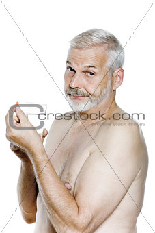 Senior man portrait take medecine pill annoyed