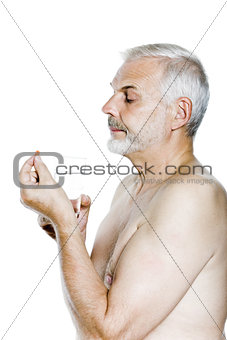 Senior man portrait take pill