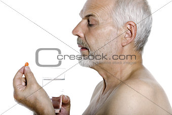Senior man portrait taking medecine pill