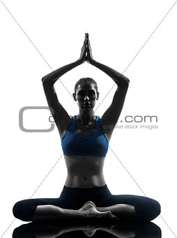 woman exercising yoga meditating sitting hands joined silhouette