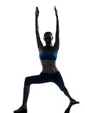 woman exercising yoga warrior position silhouette