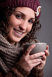 smiling woman with a mugful of a hot drink