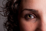 closeup of an eye of a curly haired girl