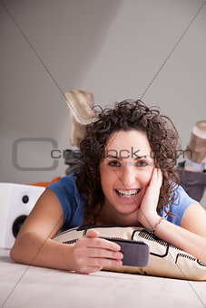 smiling girl playing videogames on her mobile