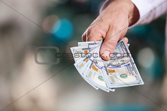 Hand with money on a blurred background
