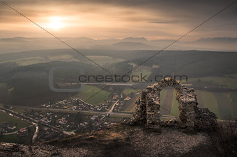 Ancient Ruins with Mountains and Village in Background