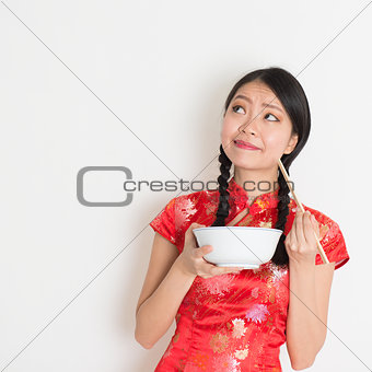 Asian chinese girl eating and thinking