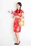 Chinese girl holding gift basket and plum blossom