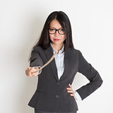 Asian female teacher holding a stick