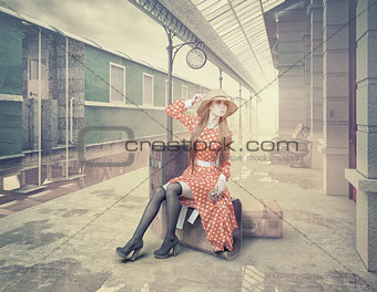 The girl sitting on the suitcase