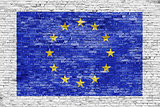 Flag of European Union over white brick wall