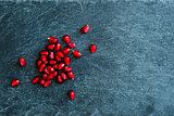 Closeup on pomegranate grains on stone substrate