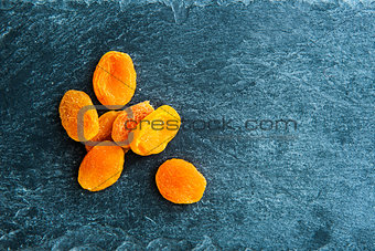 Closeup on dried apricots on stone substrate