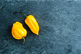 Closeup on yellow chili peppers on stone substrate