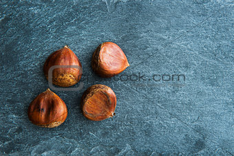Closeup on chestnuts on stone substrate