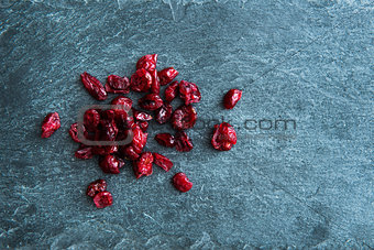 Closeup on dried lingonberries on stone substrate