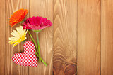 Colorful gerbera flowers and Valentine's day heart toy