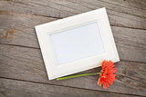 Blank photo frame and orange gerbera