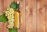 White wine bottle and bunch of white grapes