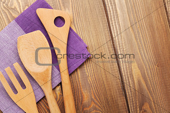 Wood kitchen utensils over wooden table background